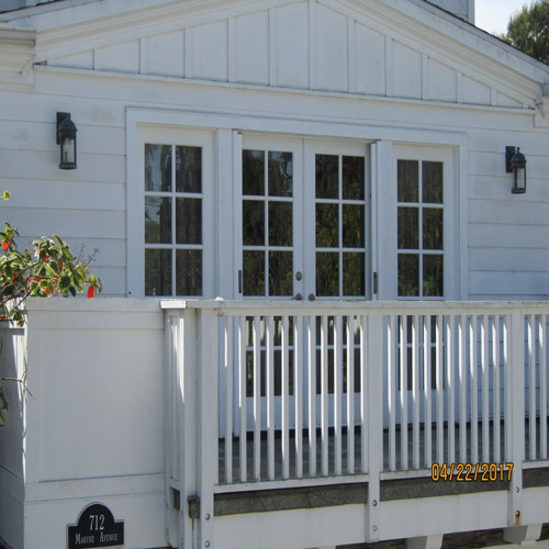 Clean white exterior siding and windows on a residential property