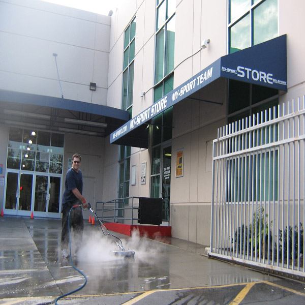 Commercial pressure washing surface cleaning at a property exterior